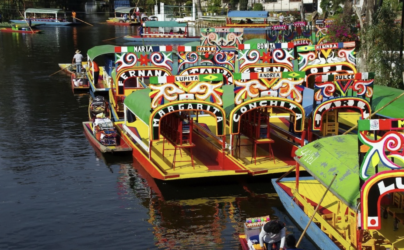 Colorful trajineras lined along the canal